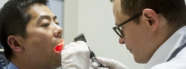 Doctor checking patient mouth