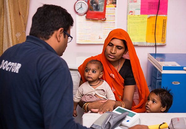 Dr. Sanket Patel at clinic talking to family